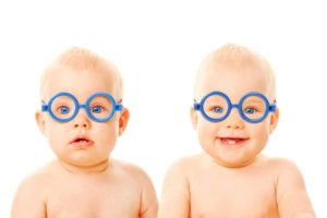 Twin boys wearing blue glasses