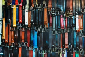 Numerous leather belts in different colors