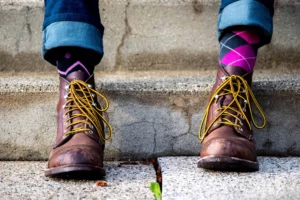 Person wearing boots with custom argyle socks