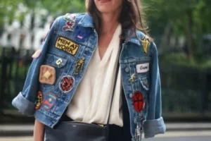 Lady wearing a jean jacket with custom patches adhered to the jacket