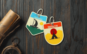 Custom embroidered keychains on wood background with compass and map